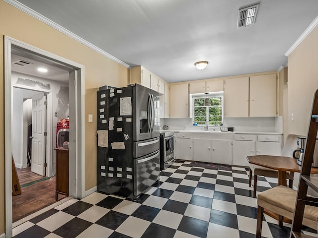 kitchen featuring cream cabinetry, stainless steel appliances, crown molding, and sink