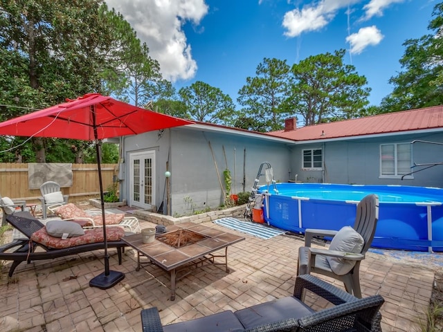 view of patio with a fenced in pool and french doors