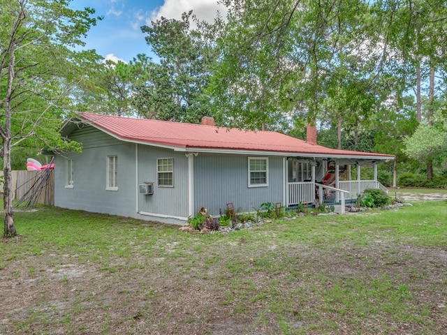 back of house featuring a porch and a yard