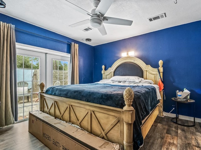 bedroom featuring a textured ceiling, ceiling fan, and dark wood-type flooring