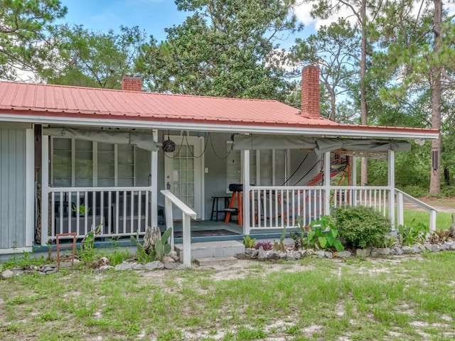 rear view of property with a porch and ceiling fan