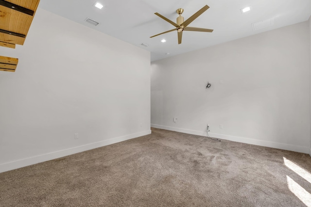 carpeted empty room featuring ceiling fan