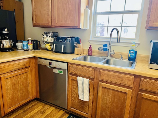 kitchen with sink, light hardwood / wood-style flooring, and dishwasher