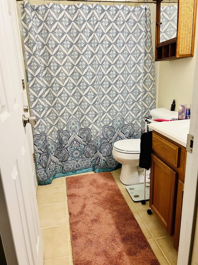 bathroom featuring tile patterned floors, toilet, and vanity