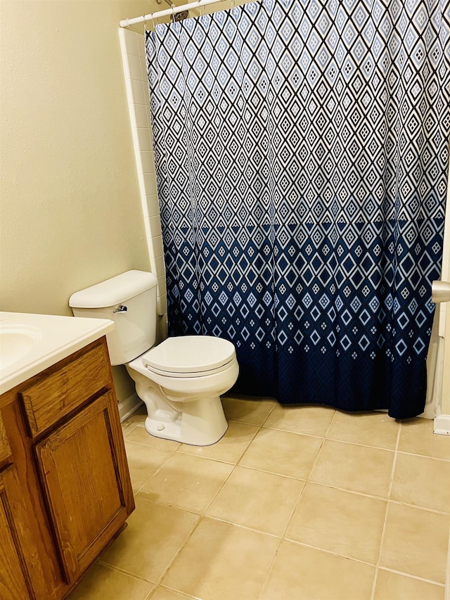 bathroom with vanity, tile patterned floors, and toilet