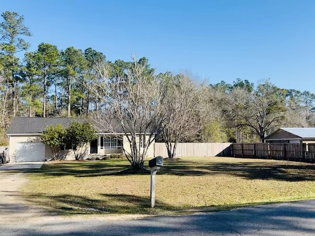 view of front of property featuring a garage and a front lawn