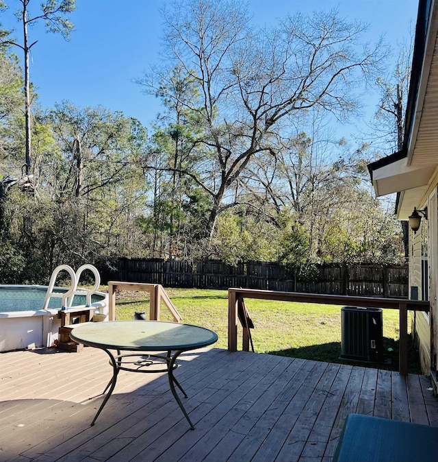 wooden terrace with a yard and cooling unit