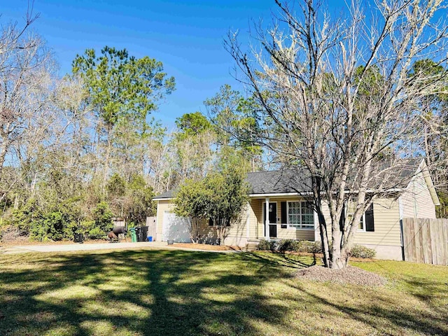 view of front of home with a garage and a front lawn