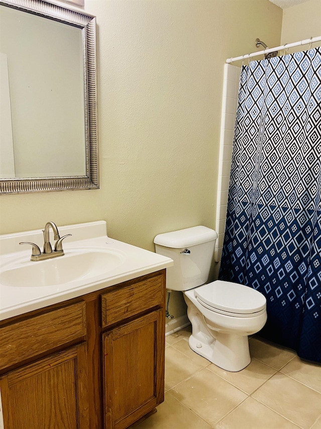 bathroom featuring tile patterned floors, toilet, and vanity