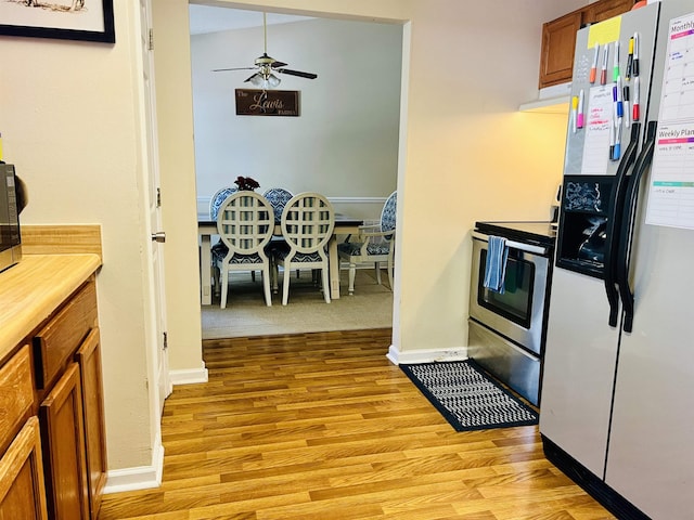 kitchen featuring light hardwood / wood-style flooring, stainless steel appliances, and ceiling fan