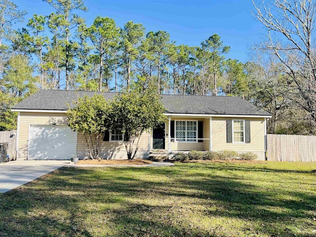 ranch-style home with a garage and a front lawn