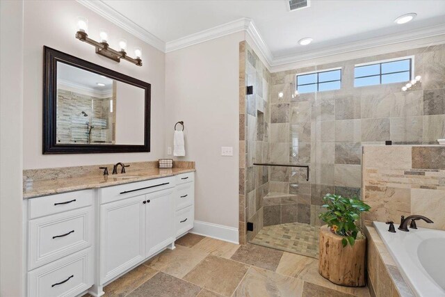 6476 Tracy Ln, Tallahassee, FL 32309 - bathroom featuring a shower stall, a tub with jets, vanity, crown molding, and baseboards