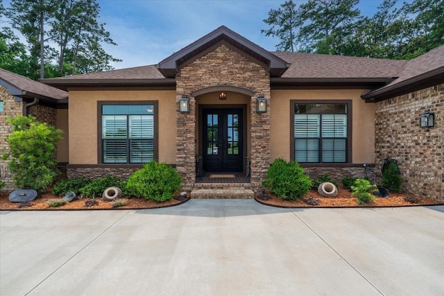 6476 Tracy Ln, Tallahassee, FL 32309 - doorway to property featuring french doors, stone siding, and stucco siding