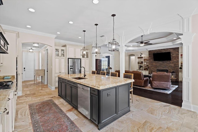 6476 Tracy Ln, Tallahassee, FL 32309 - kitchen featuring arched walkways, a ceiling fan, decorative columns, stainless steel appliances, and ornamental molding