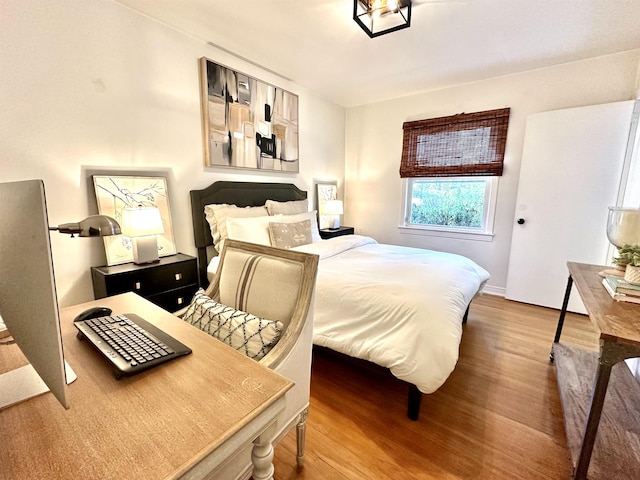 bedroom with hardwood / wood-style floors