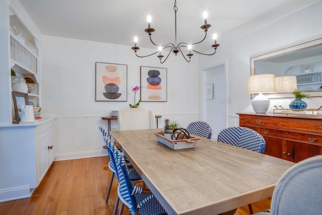 dining area featuring a notable chandelier and light wood-type flooring