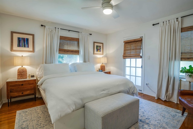 bedroom with ceiling fan and dark hardwood / wood-style floors