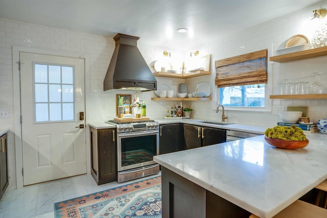 kitchen with sink, stainless steel stove, dark brown cabinetry, and custom exhaust hood