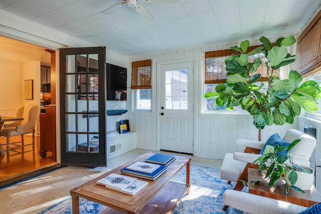 interior space with ceiling fan