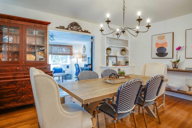 dining area with hardwood / wood-style flooring and a notable chandelier