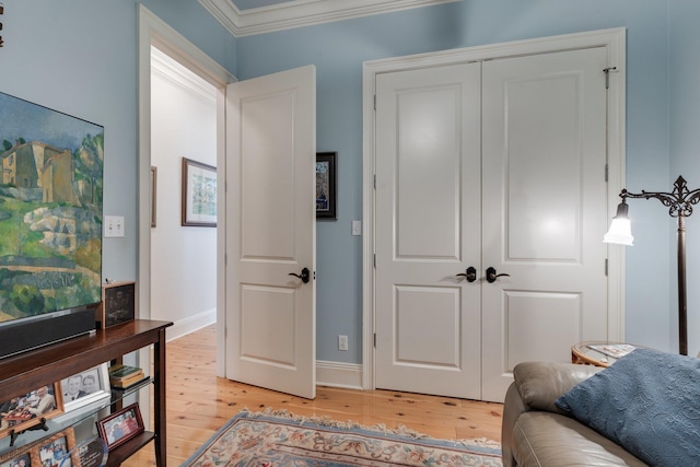 sitting room with light hardwood / wood-style floors and ornamental molding