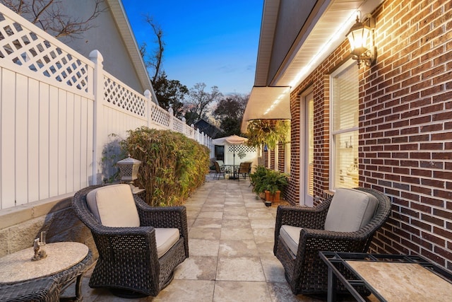 view of patio terrace at dusk