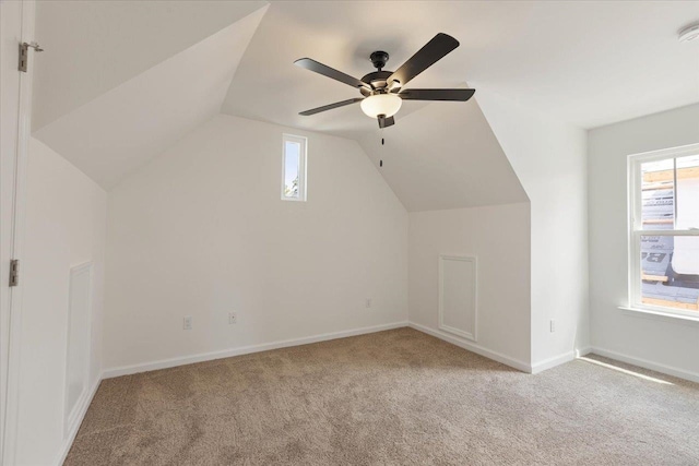 additional living space with lofted ceiling, light carpet, and ceiling fan