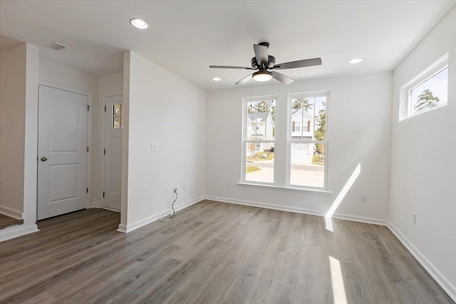 spare room with ceiling fan and light wood-type flooring