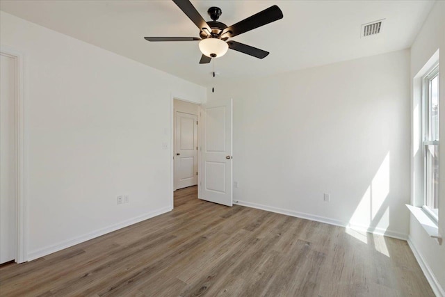 empty room featuring light hardwood / wood-style flooring and ceiling fan