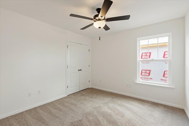 carpeted empty room with ceiling fan