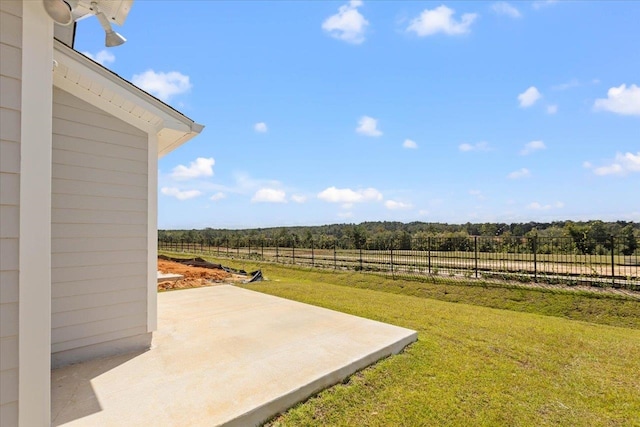 view of yard with a rural view and a patio area