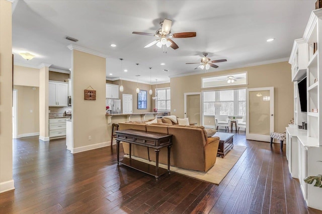 living room with dark hardwood / wood-style flooring and ornamental molding