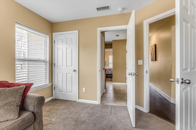 living area with light colored carpet and a wealth of natural light