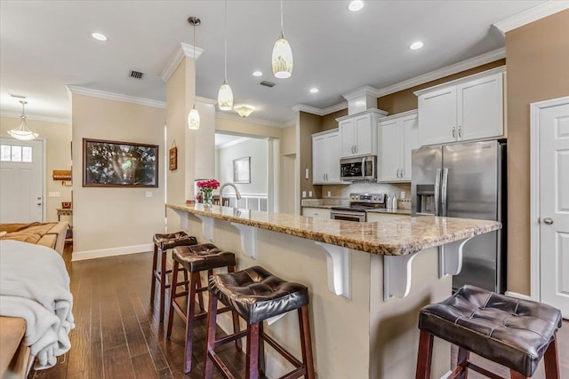 kitchen with decorative light fixtures, a kitchen breakfast bar, and stainless steel appliances