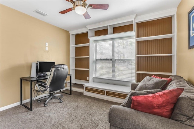 carpeted office space with ceiling fan