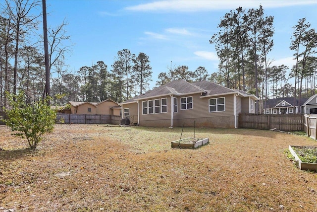 back of house with a lawn