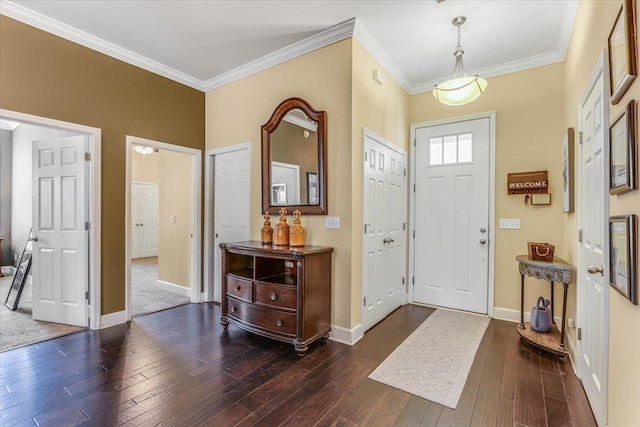 foyer entrance with dark wood-type flooring and crown molding