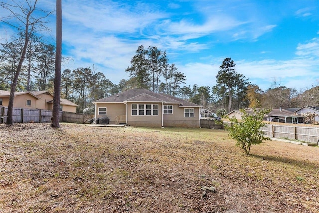 rear view of property with a yard