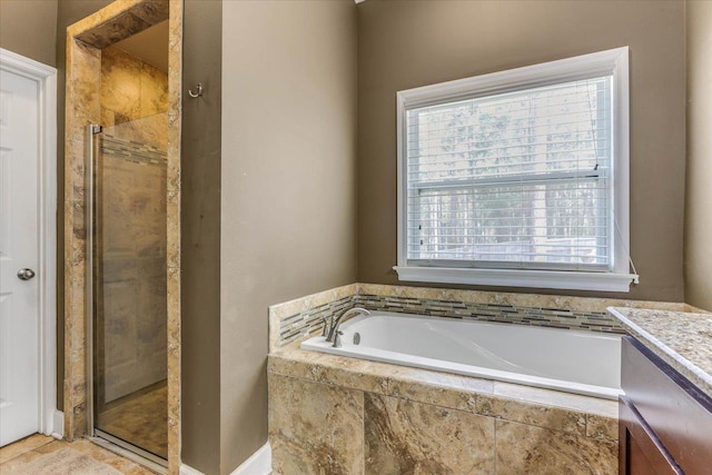 bathroom with plenty of natural light, vanity, and separate shower and tub