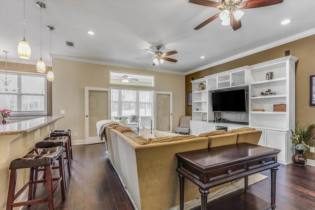 living room with ceiling fan, dark hardwood / wood-style floors, and crown molding