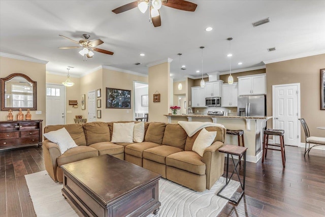 living room featuring sink, ceiling fan, ornamental molding, and dark hardwood / wood-style flooring