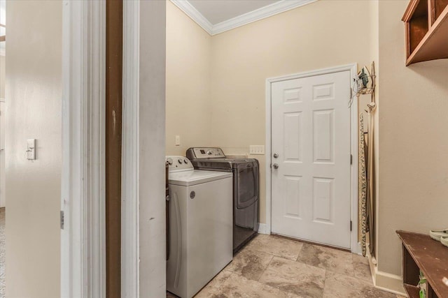 washroom featuring washer and dryer and ornamental molding