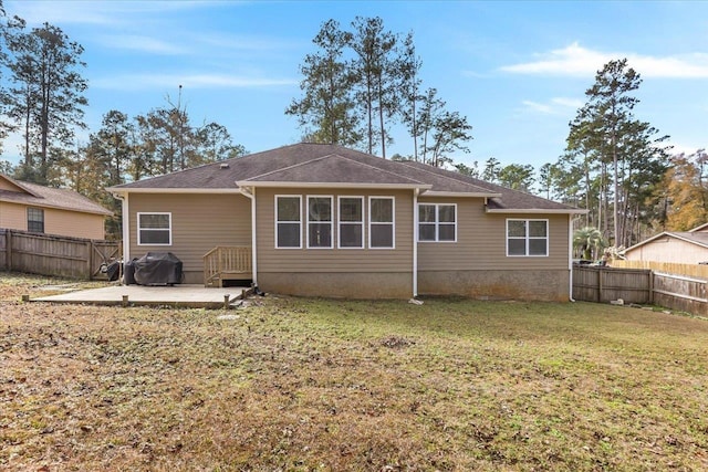 rear view of house featuring a patio and a yard