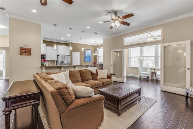 living room with ceiling fan, french doors, ornamental molding, and dark wood-type flooring