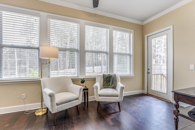 living area featuring hardwood / wood-style flooring, a healthy amount of sunlight, and ornamental molding