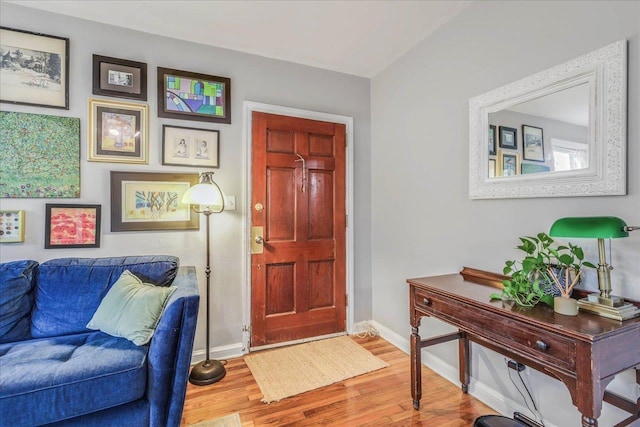 entrance foyer featuring baseboards and wood finished floors