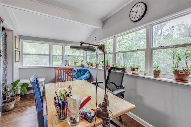 sunroom with vaulted ceiling with beams, baseboards, plenty of natural light, and wood finished floors