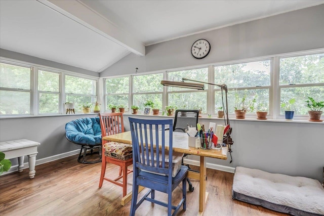 sunroom / solarium featuring baseboards, a healthy amount of sunlight, vaulted ceiling with beams, and wood finished floors