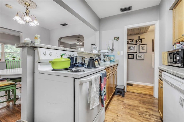 kitchen featuring visible vents, white appliances, light wood-style floors, ceiling fan, and light countertops
