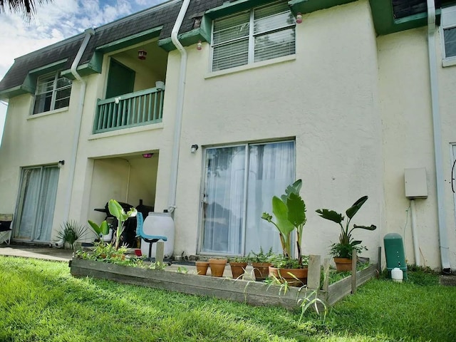 rear view of property featuring a balcony